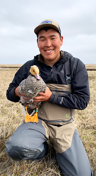 Paul Larson holds a spectacled eider duck.
